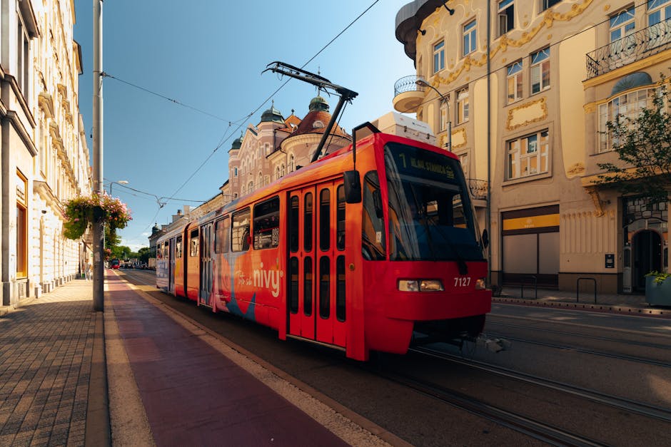 Bright tram passing through a historic street in Bratislava, Slovakia, highlighting city charm.