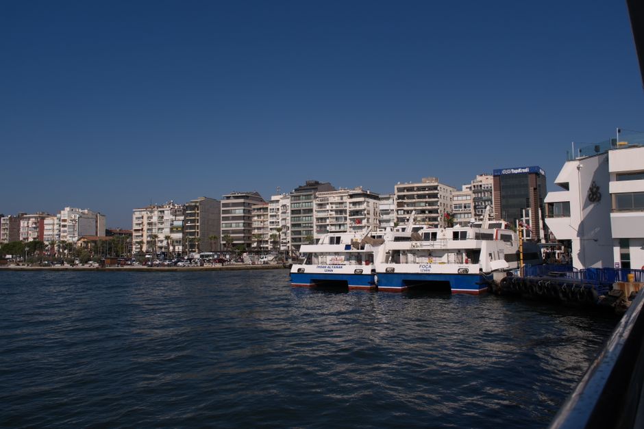 Beautiful day view of the waterfront in İzmir, Türkiye with ferries and city architecture.