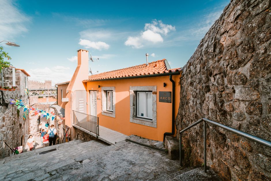 Explore a picturesque alley with vibrant architecture and lively pedestrian activity in Porto, Portugal.