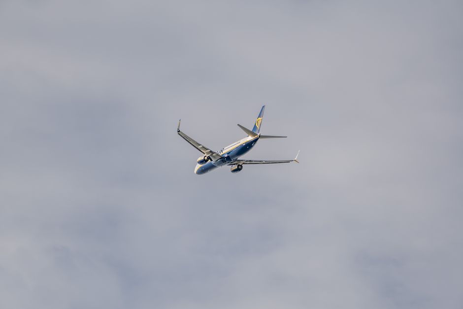 A passenger airplane flying high above the clouds, showcasing mid-flight tranquility.