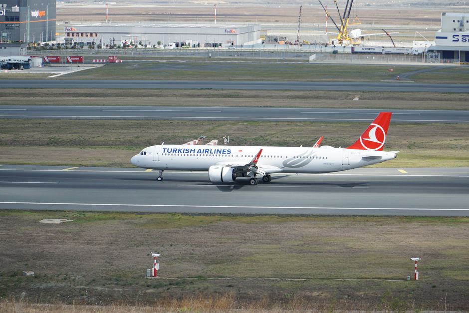 A Turkish Airlines plane taxiing at Istanbul Airport, captured from a distance.