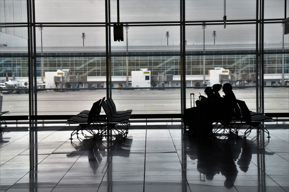 Travellers waiting at an airport departure lounge