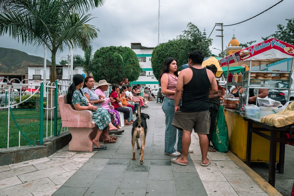 A lively street scene in Simbal, Peru, featuring people, a street vendor, and local culture.